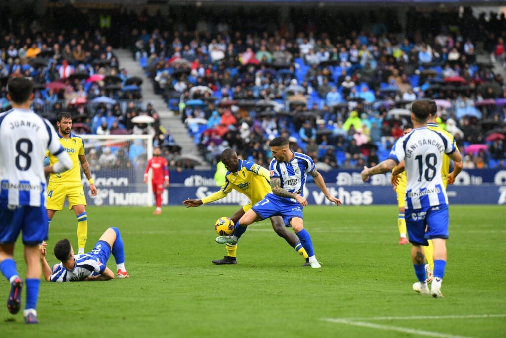 Jugadores del Málaga CF y Cádiz CF disputan el balón en La Rosaleda. Cádiz CF